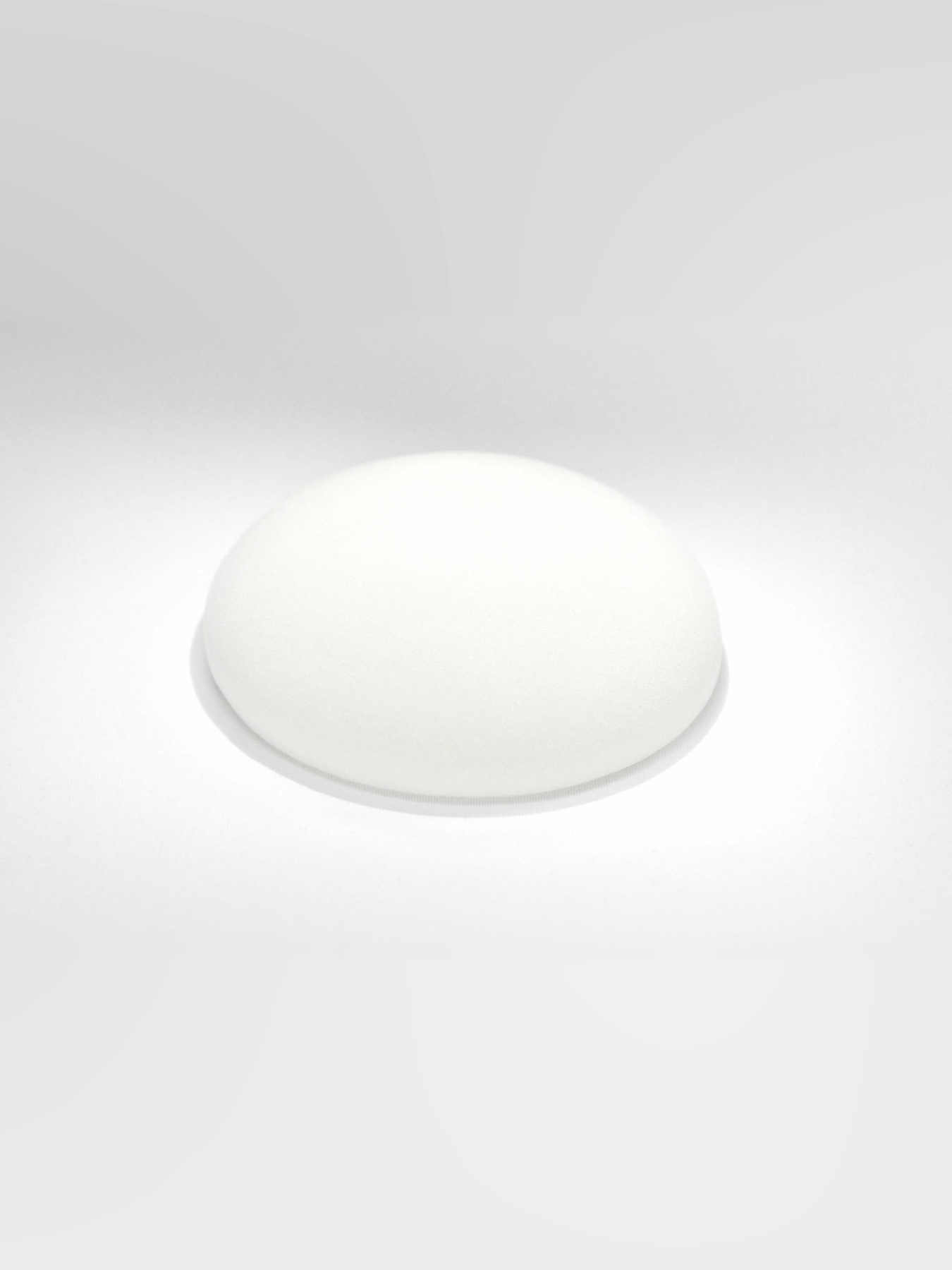 Silicone breast implant on a light background
